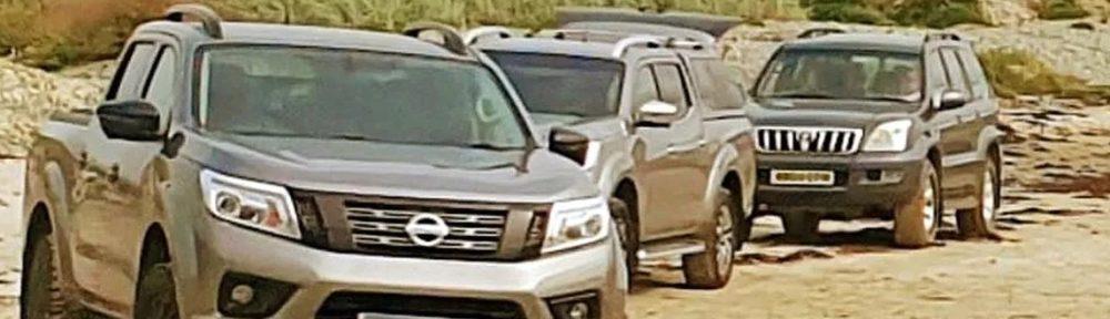 SUVs on the beach , garbage beach of Traeth Kisgod y Llanrw, near Llanfrog, on the island of Anglesey in Wales