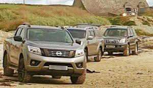 SUVs on the beach , garbage beach of Traeth Kisgod y Llanrw, near Llanfrog, on the island of Anglesey in Wales